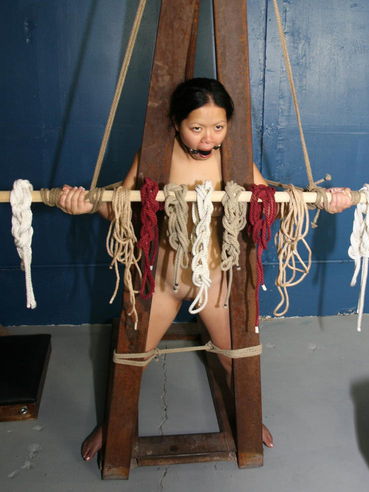Oriental Angela Decorative With Small Tits And Hairless Snatch Gets Tied To Special Construction