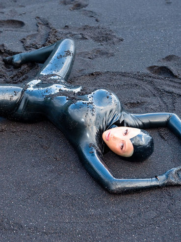 Hot Bodied Latex Doll Bianca Beauchamp Poses In Wet Black Sand On The Beach